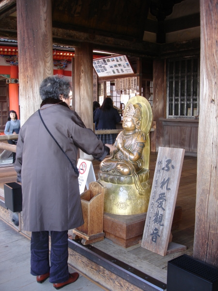 Rubbing the Buddha for luck